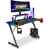 XTREME by O&S Carbon Fibre Effect Z Frame RGB PC Computer Gaming Desk with RGB LED Lights, Monitor Screen Stand, Desktop Tower Stand Trolley, Cable Management, Headset Hook & Drinks Cup Holder, Black - Packed Direct UK